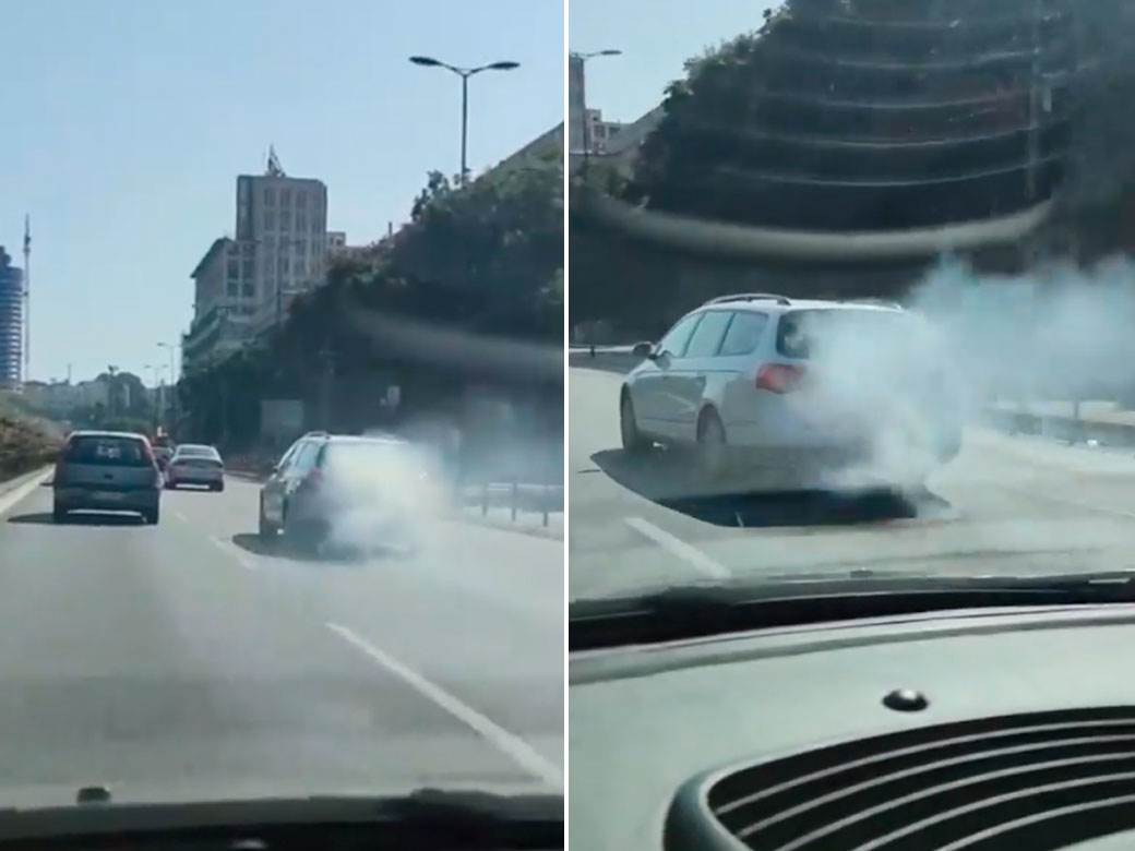  Čovek vozi auto koji se dimi u Beogradu 